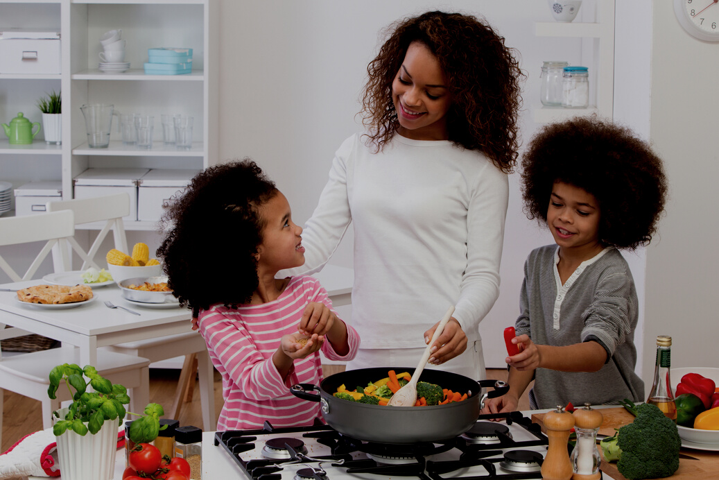 Mother and Children Cooking Family Meal